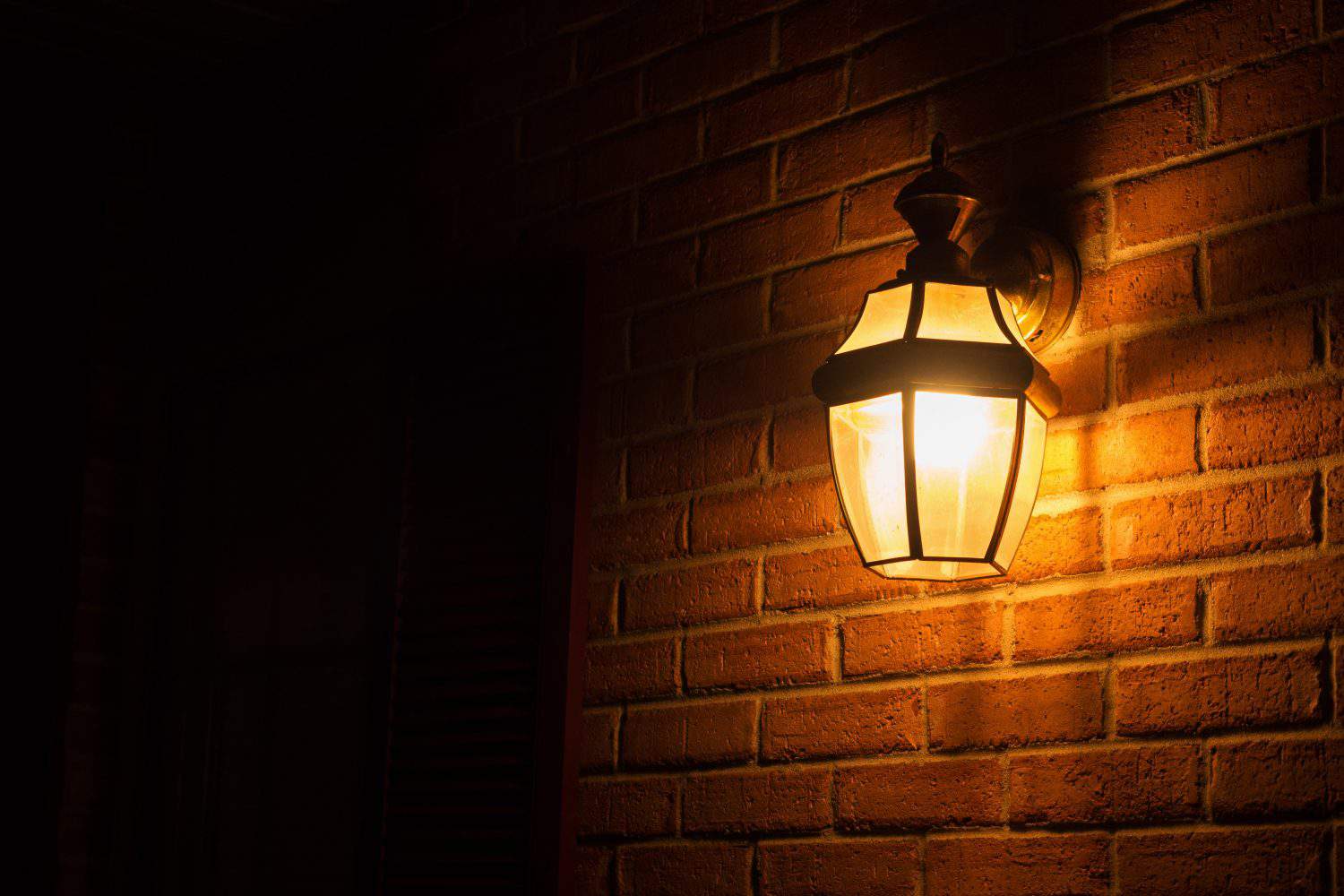 Warm light lantern illuminating the front porch at night