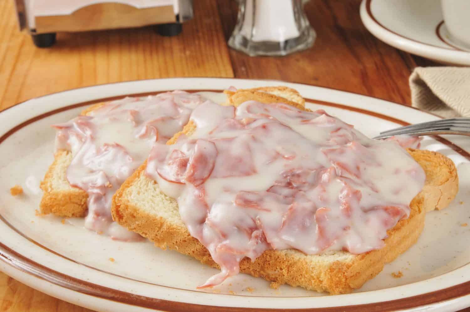 Creamed chipped beef on toast with a cup of coffee