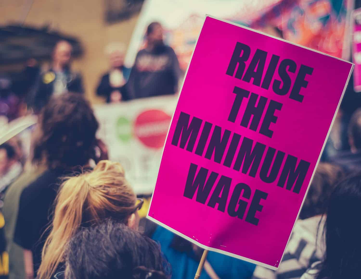 A Raise The Minimum Wage Sign At Worker's Rights Protest Or Rally