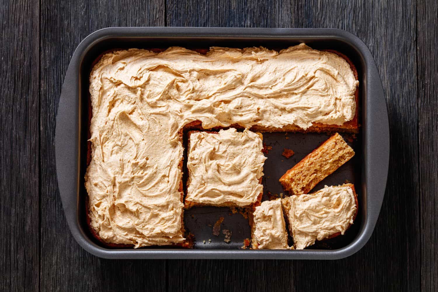 Peanut Butter Sheet Cake topped with super creamy and sweet peanut butter icing in a baking dish, horizontal view from above, american dessert, flat lay