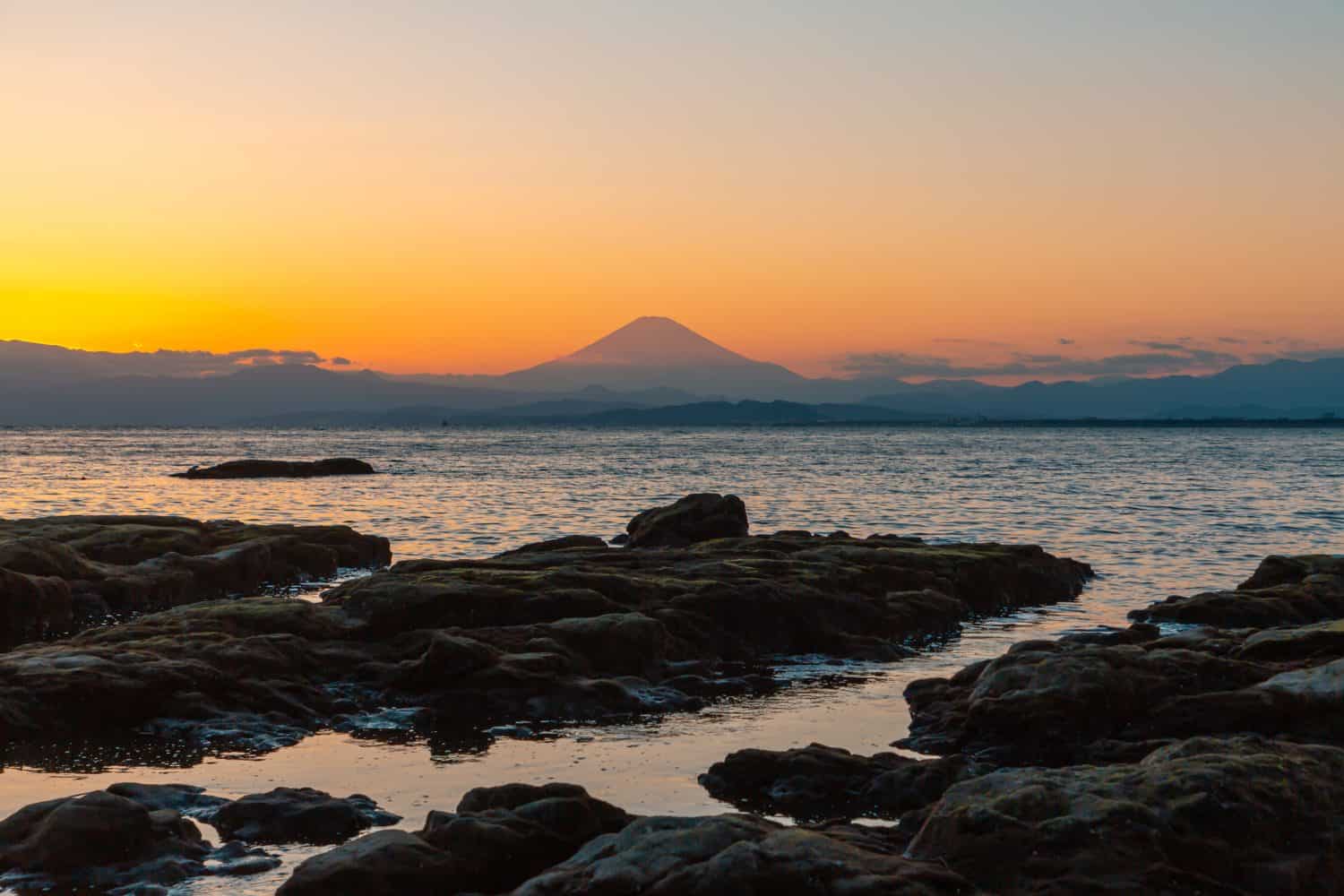 Twilight silhouette of Mount Fuji and the seashore at Enoshima Island It is a famous place in Kamakura. Japan