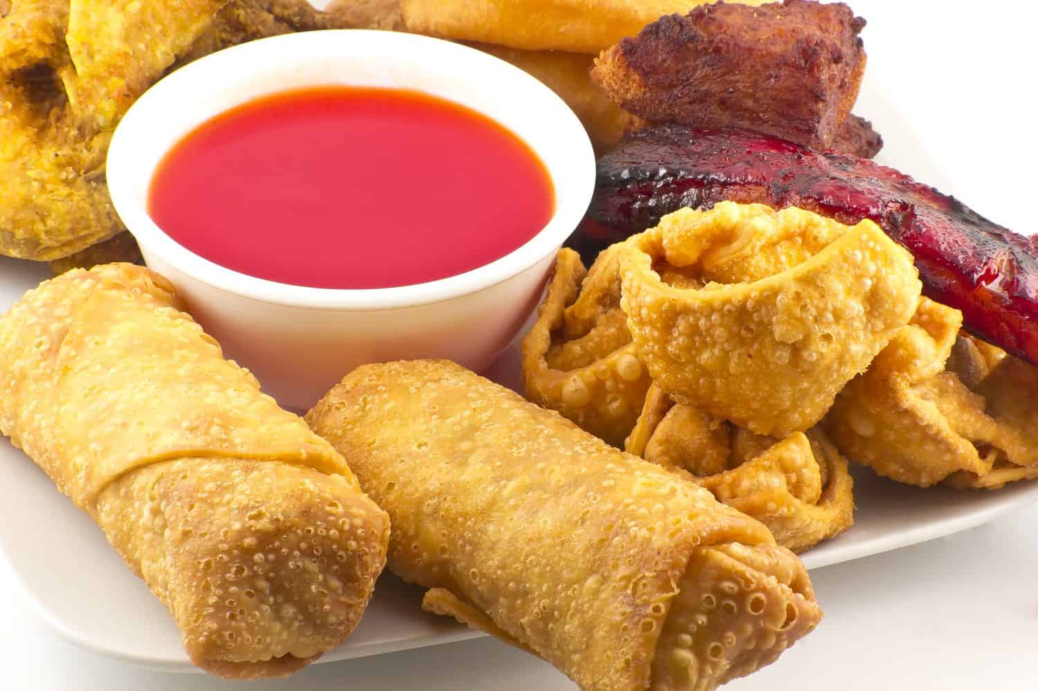 Pu pu platter with crab rangoon, egg rolls, fried chicken, BBQ Beef sticks, and fried wontons with sweet sauce