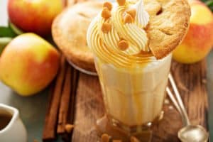 Apple pie milkshake with caramel syrup and a piece of pie