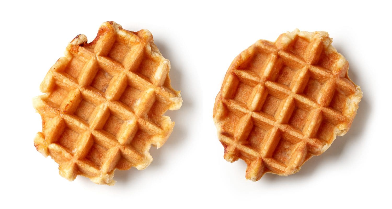 two freshly baked belgian waffles isolated on white background, top view