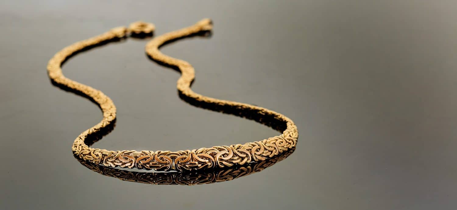 14 K gold chain necklace on black background