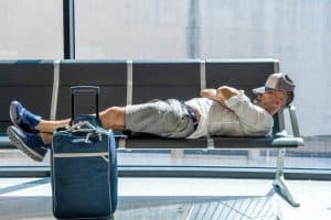 Italian boy lying awaits the call for his flight