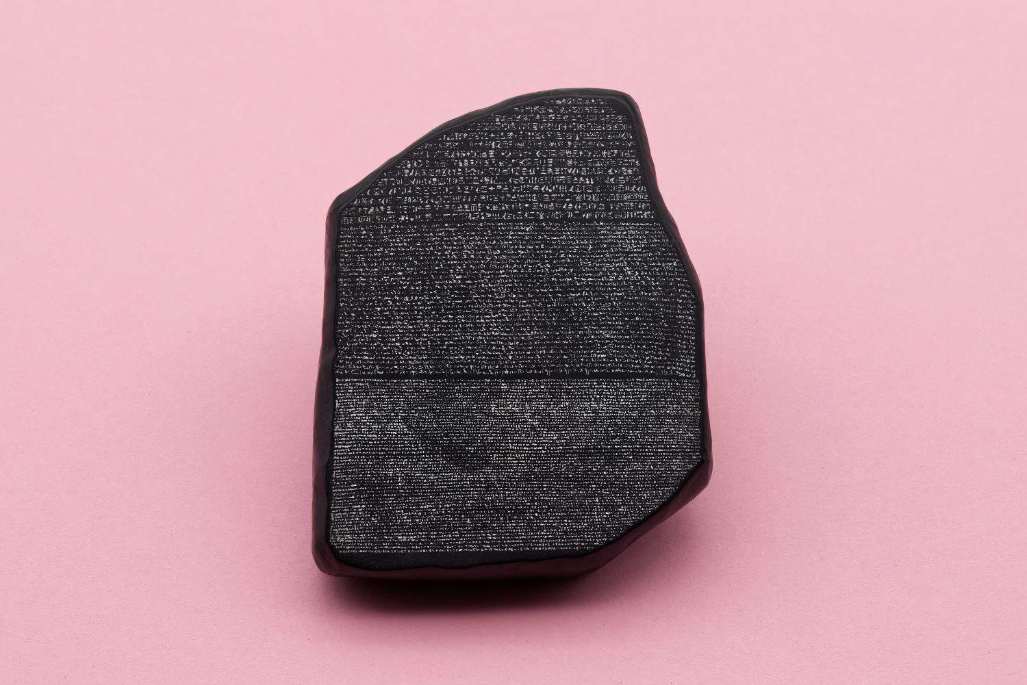 The Rosetta Stone model isolated on pink background.