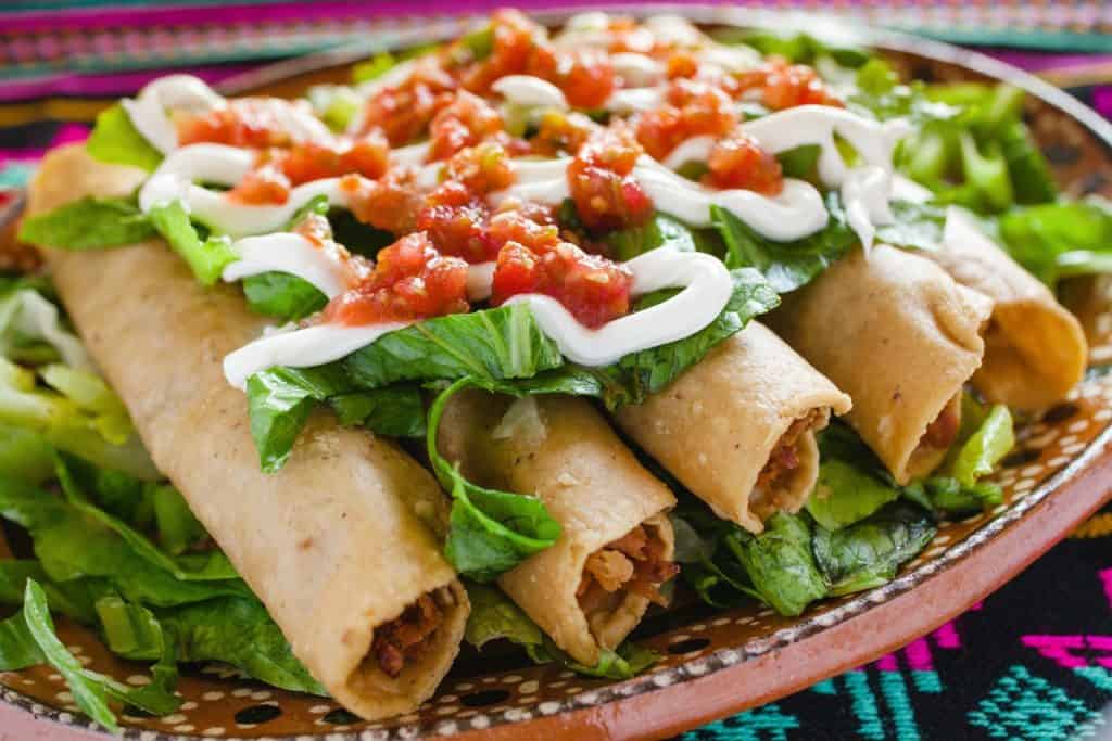 flautas de pollo, chicken tacos and spicy Salsa Homemade Mexican food in mexico city