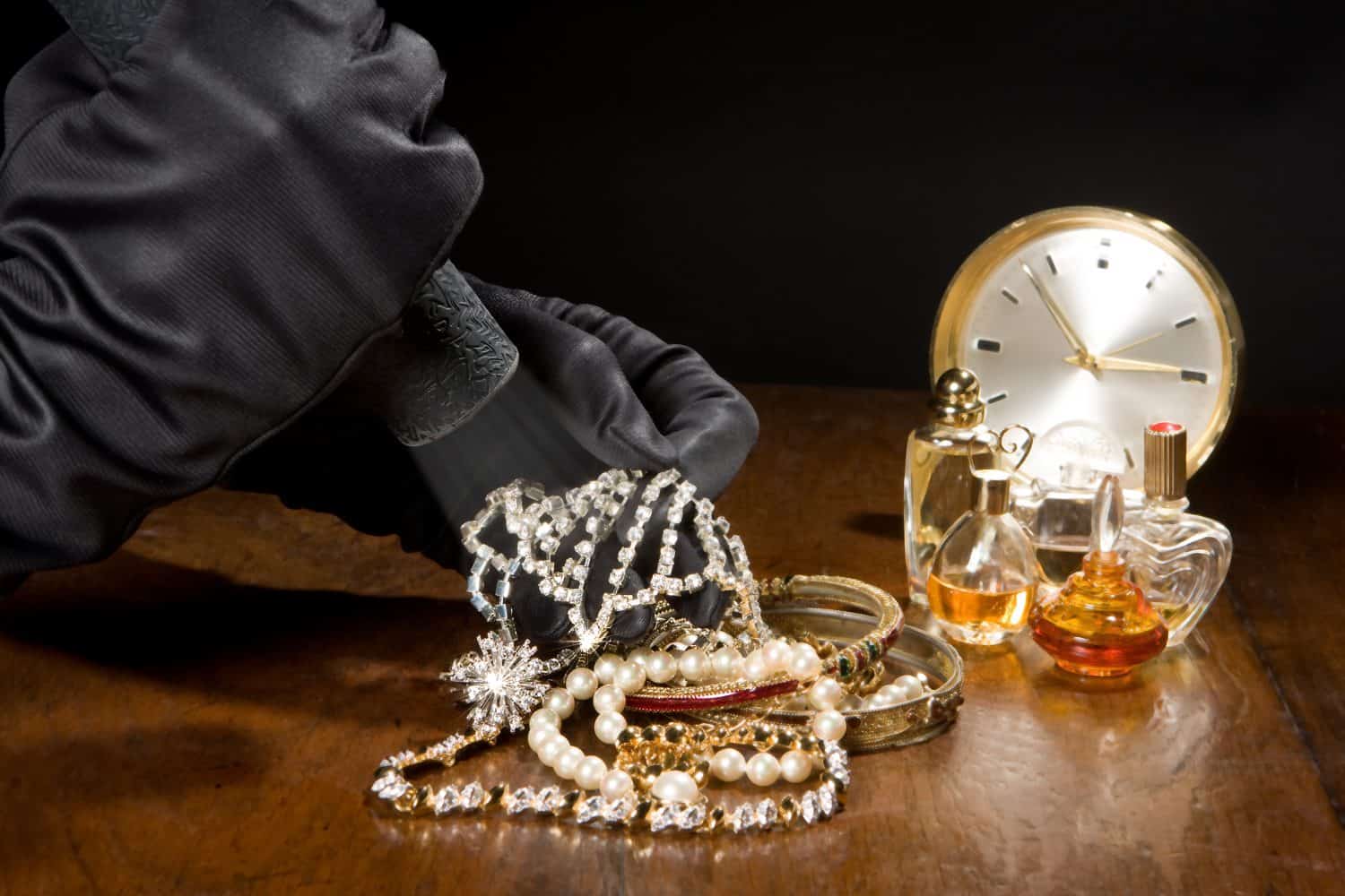 Hands of a jewelry thief with black gloves