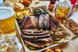 texas style bbq tray with smoked brisket, st louis ribs, pulled pork, chicken, hot links, and sides