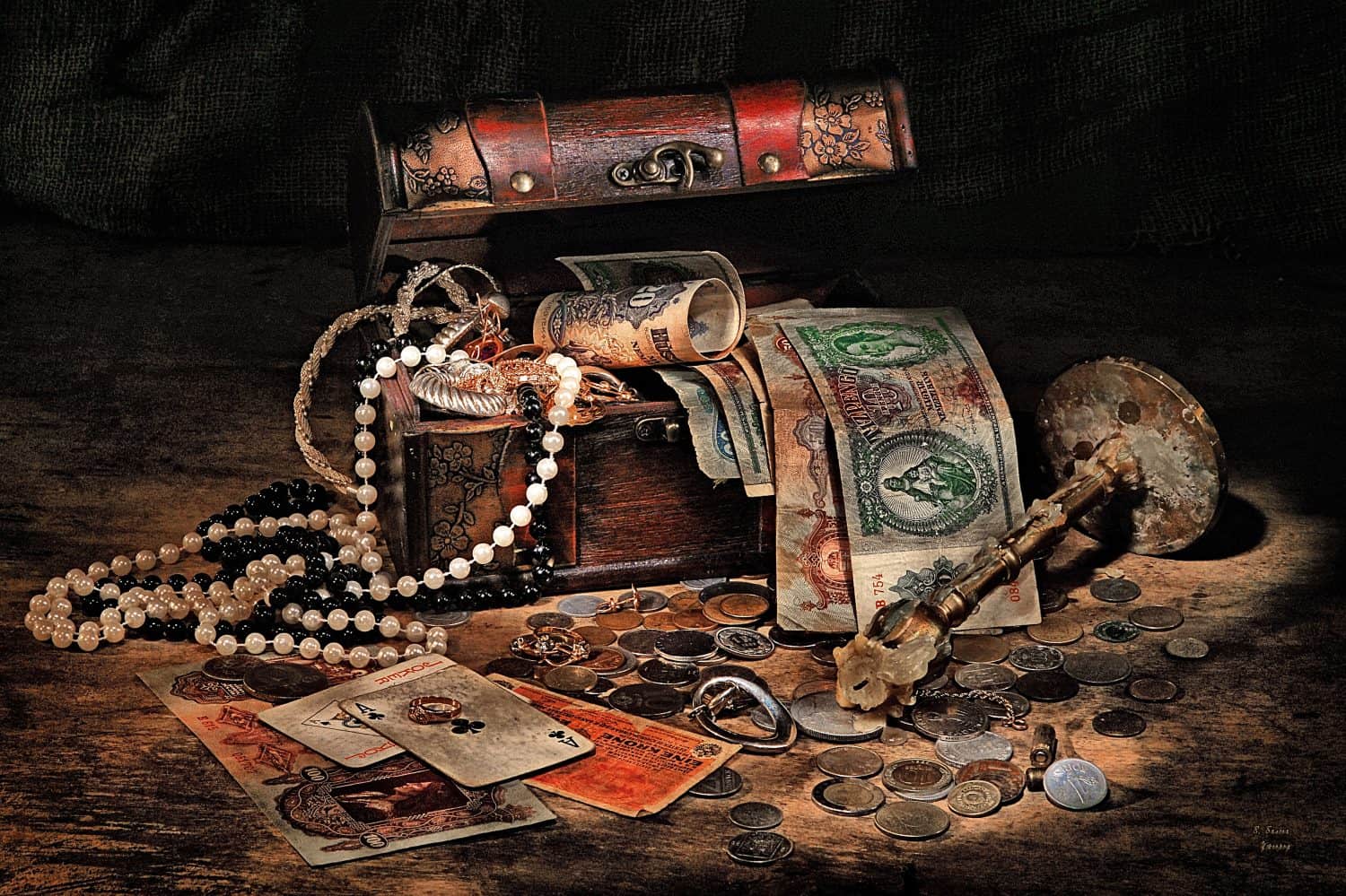 Still life with treasures, cards, candlestick on a dark background