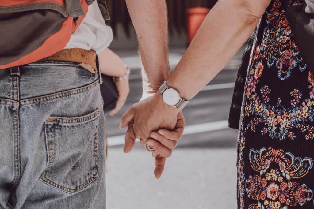 Couple holding hands in public