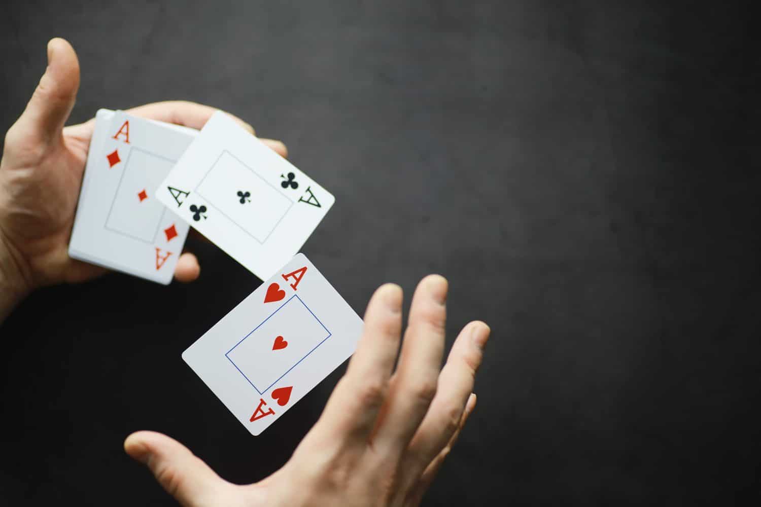 The concept card tricks and presentations. The concept of a sharpie in games. Flying cards in the air. A magician raises cards with the power of thought.