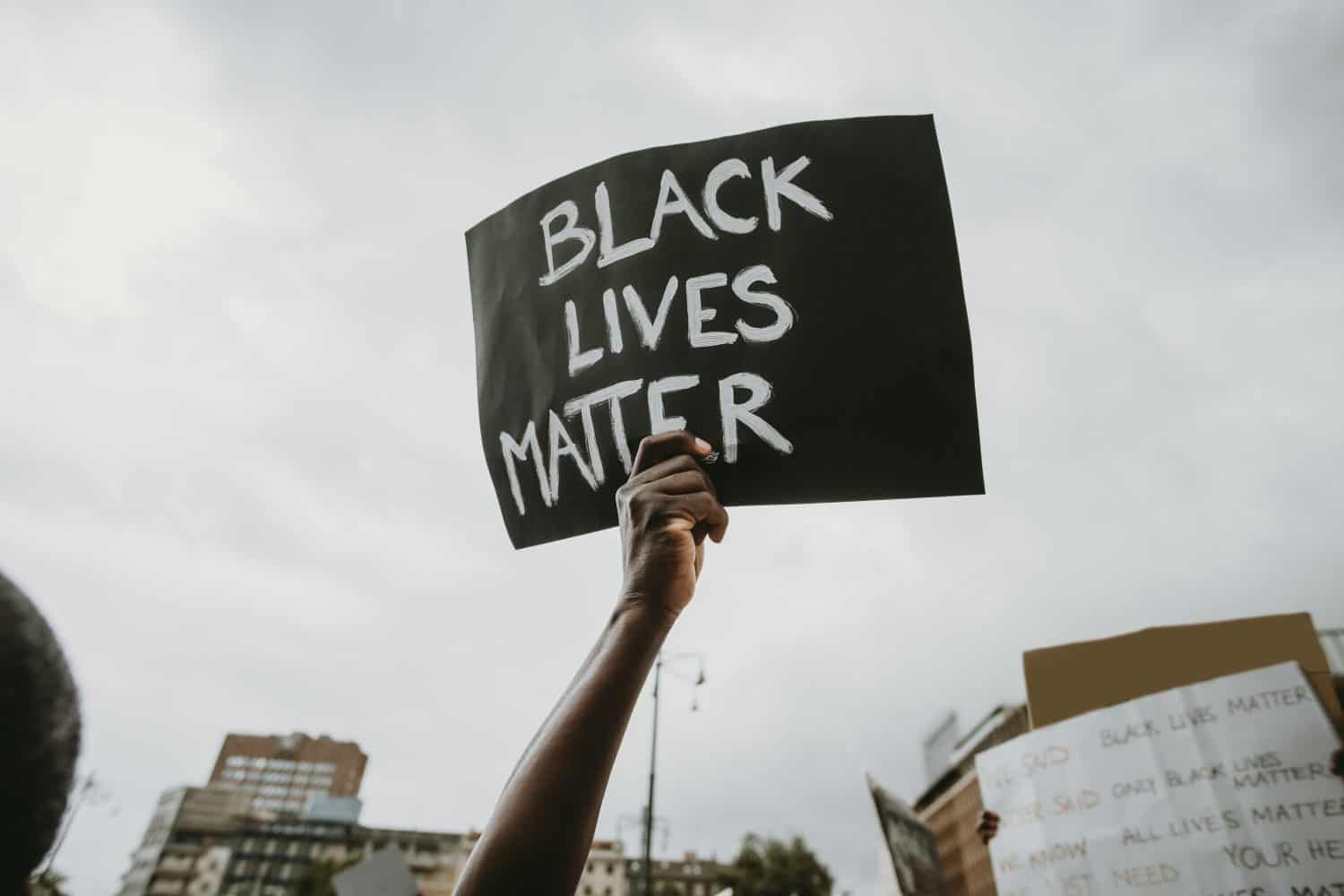 Black lives matter movement protesting in Milan, claiming for antiracism and equal human rights holding "Black lives matter" picket sign