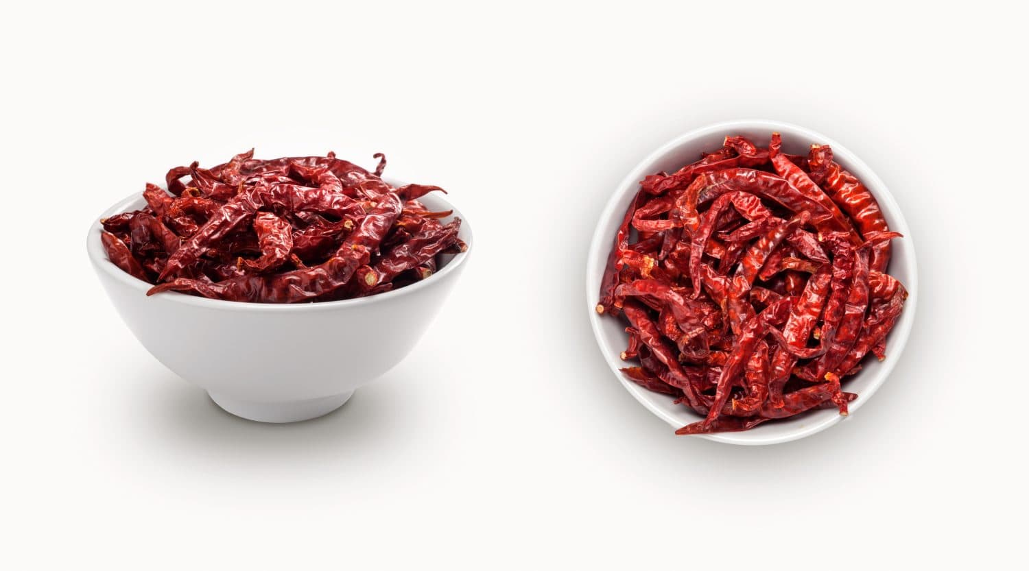 red dry chili in a small bowl, isolated on white background, view from front and top