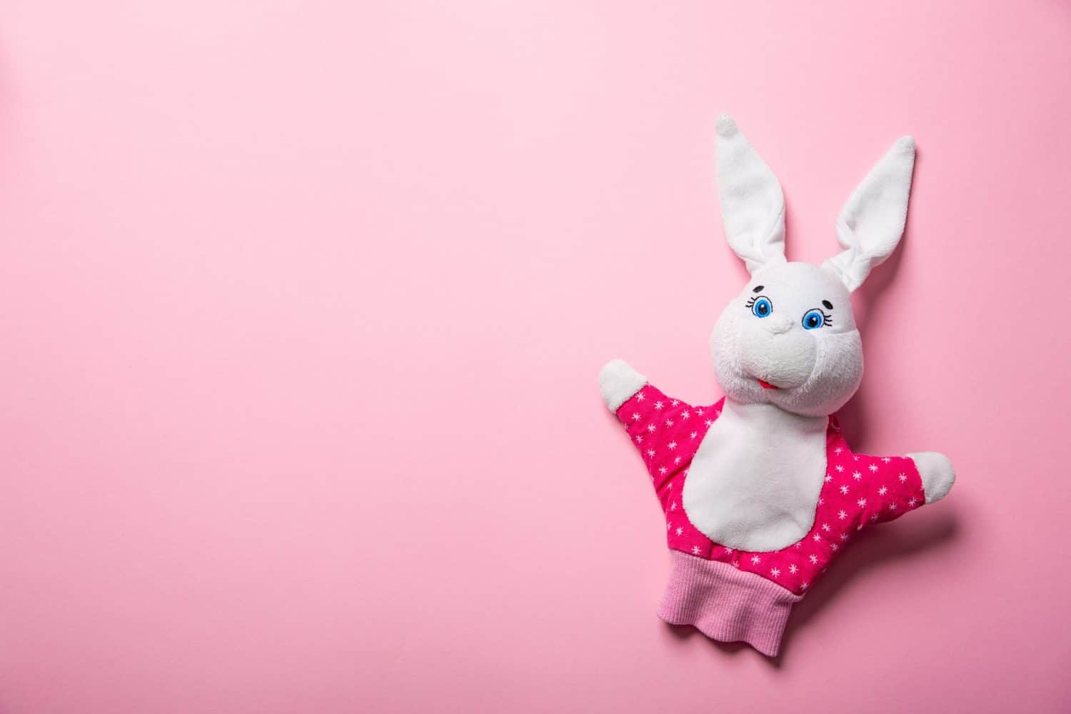 Banner with Easter bunny isolated on pink background with copy space, empty text place. Education toy theater online course. Hand puppet. Sewing hobby. Fairy tale character. Fluffy baby play friend