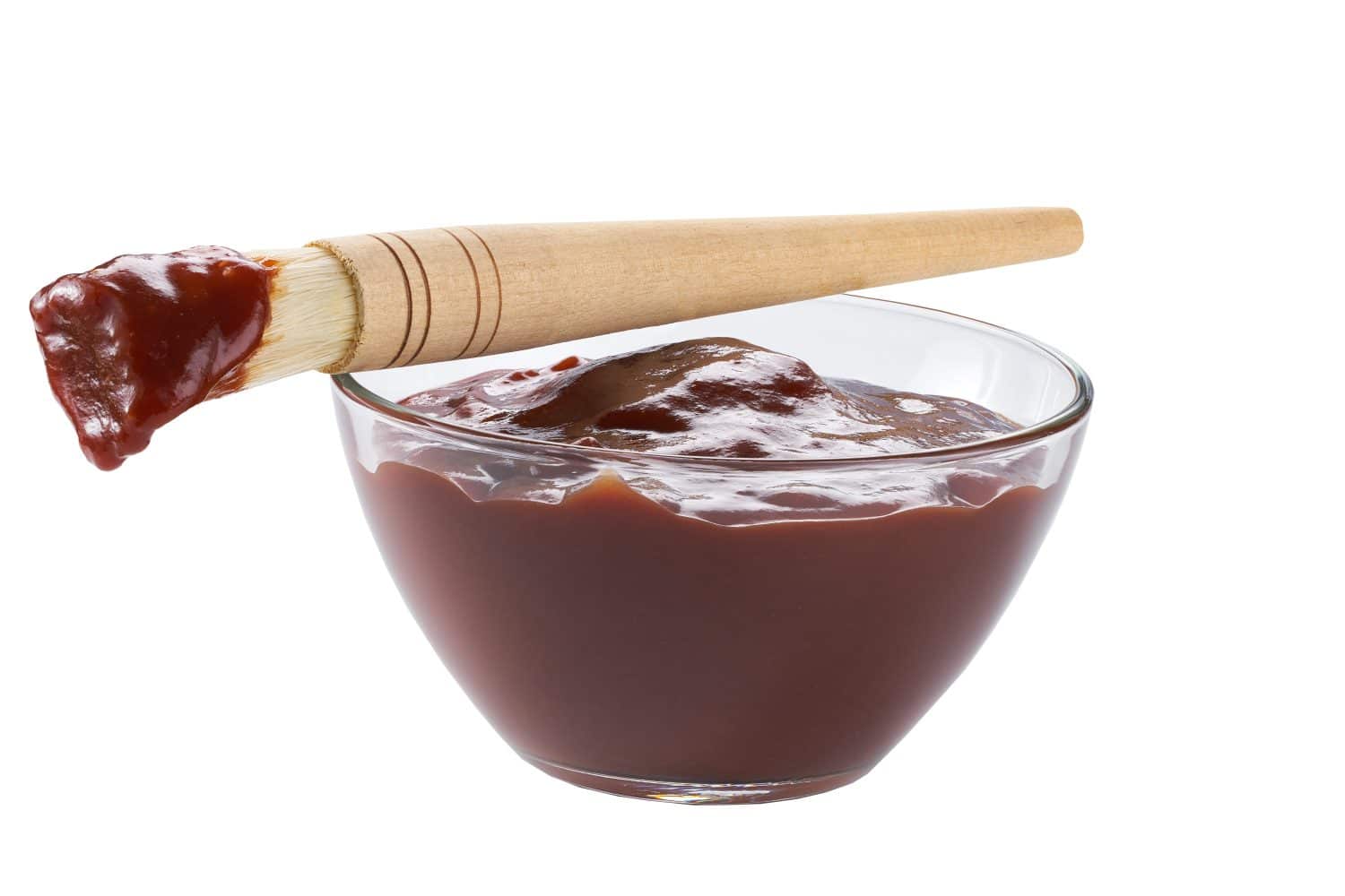 Barbecue sauce in a saucer with basting brush isolated on a white background. Glass dish of barbecue sauce with basting brush