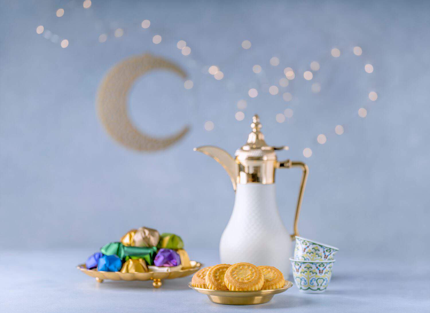 Traditional arabic Eid al Adha, Eid al Fitr sweets .Maamoul , coffee pot with chocolate candies . Muslim holiday greeting card