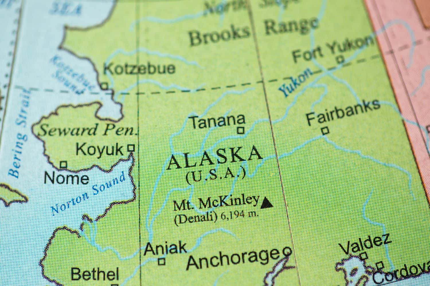 Map view of Alaska on a geographical globe.