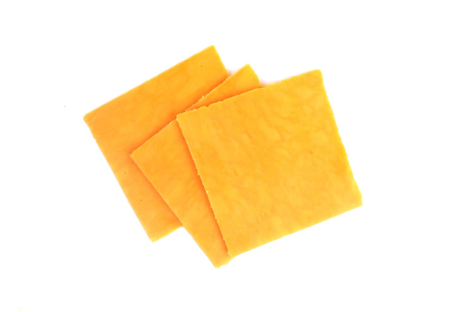 pieces of cheddar cheese on a white background