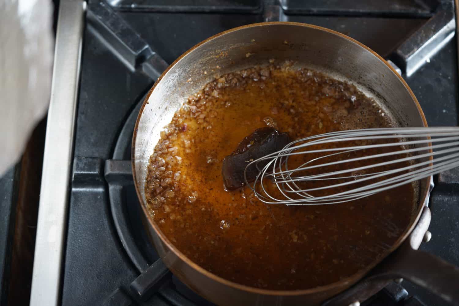 A chunk of meat glaze stirred into a deglazed pan