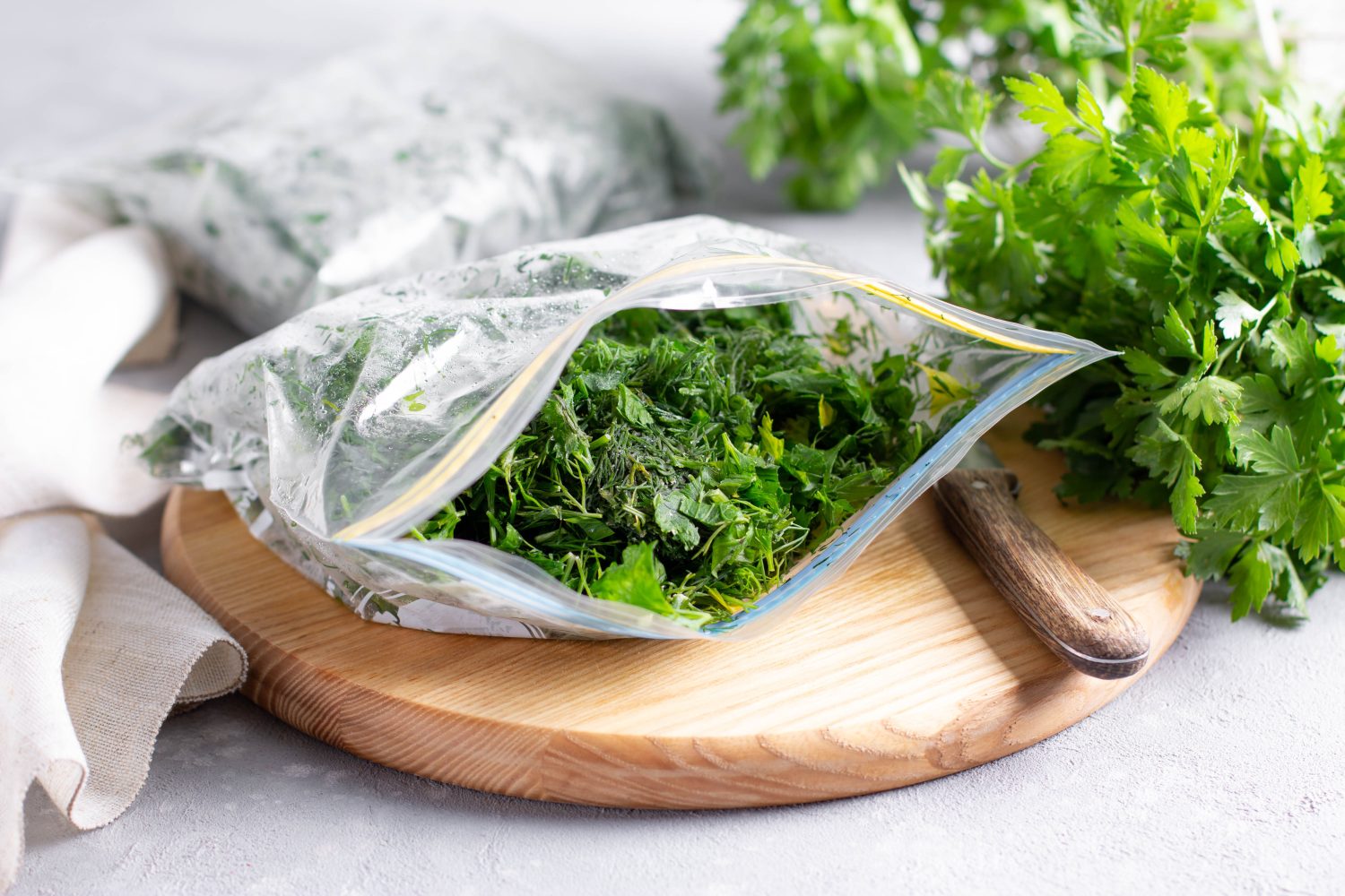 Frozen parsley in a plastic bag. Frozen vegetables. Concept of healthy eating.