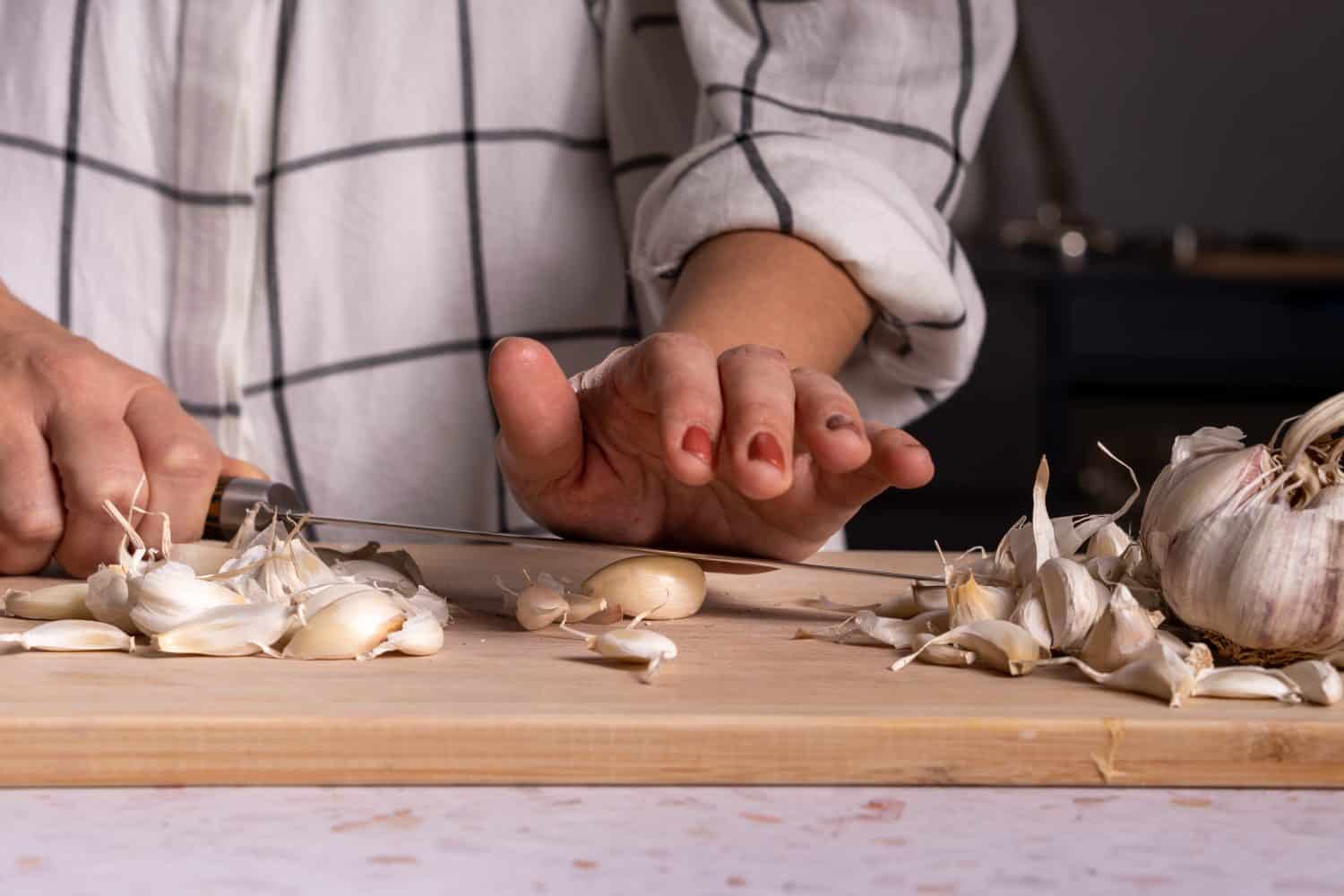 Cutting and peeling garlic cloves with a knife