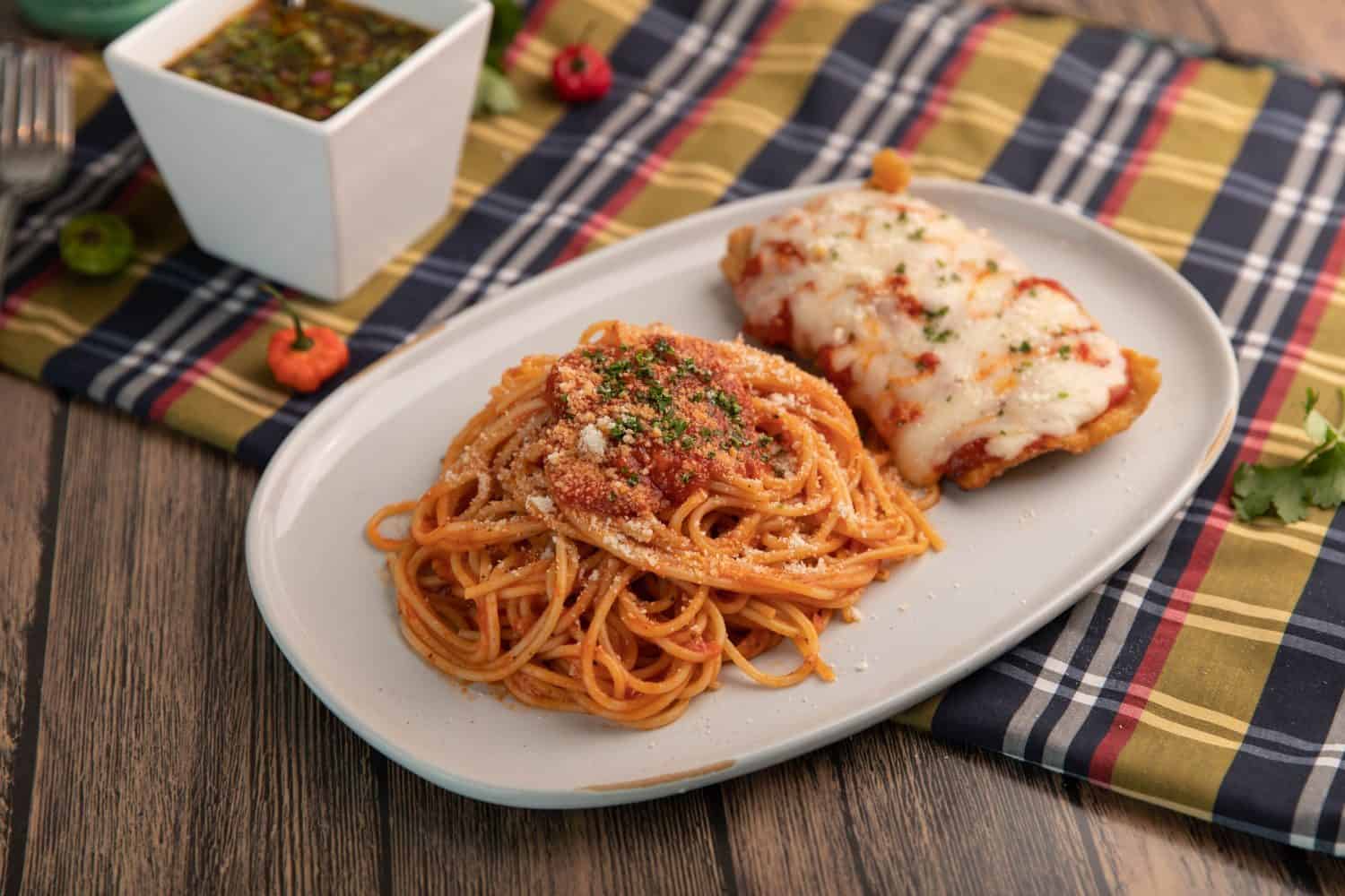 Chicken parmesan with spaghetti and parsley garnish