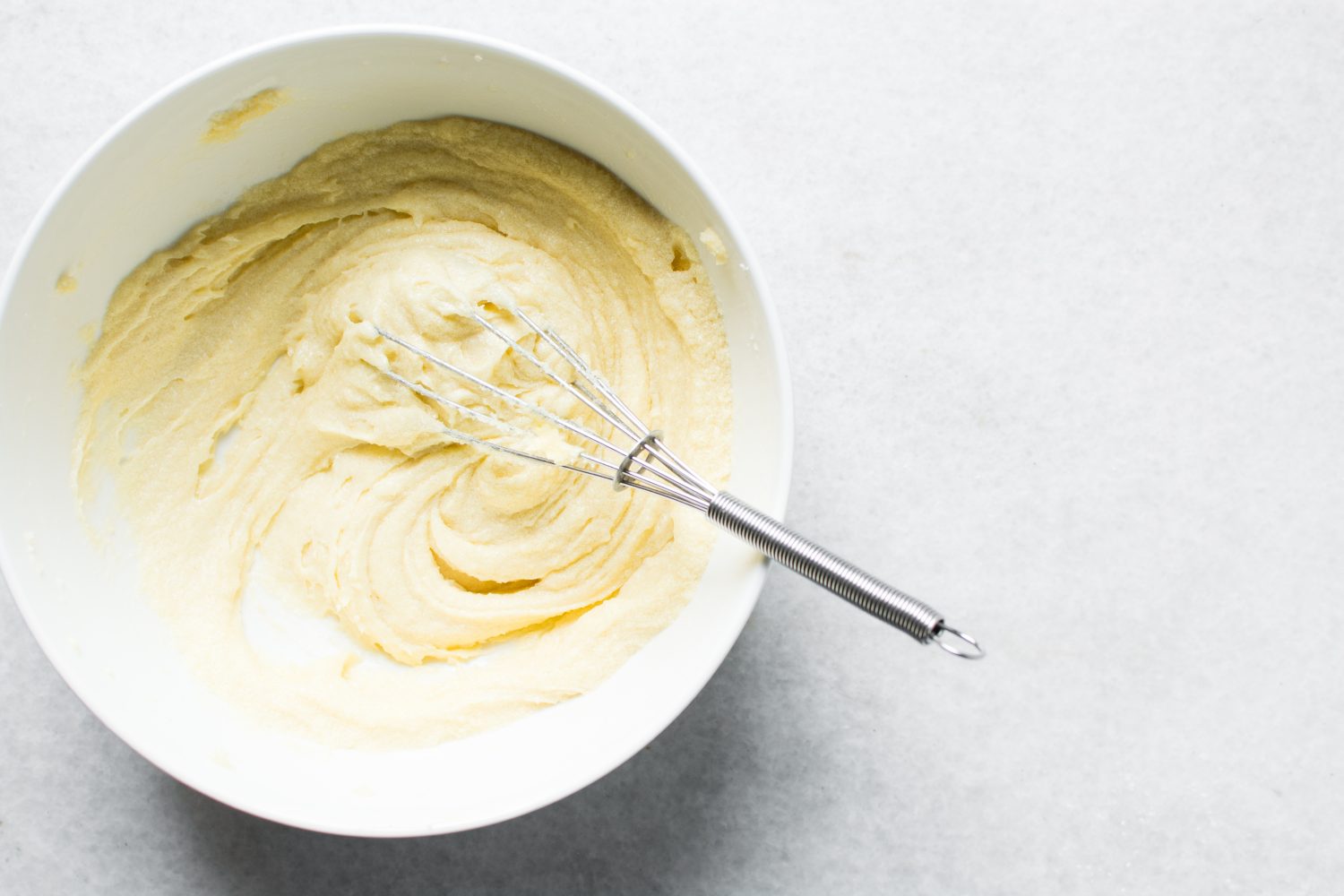 Top view of Creaming butter and sugar with a whisk, the process of making a cake, overhead view of mixing butter and sugar to make a pound cake