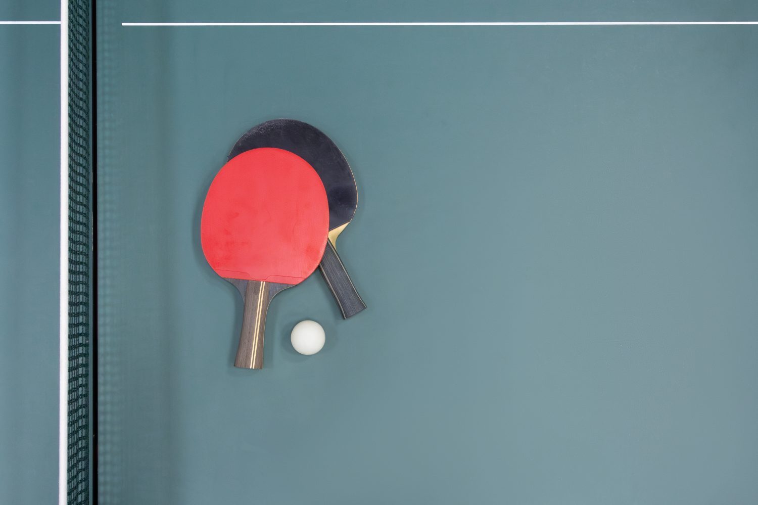 Table tennis ball and two rackets on the table. Top view - stock photo