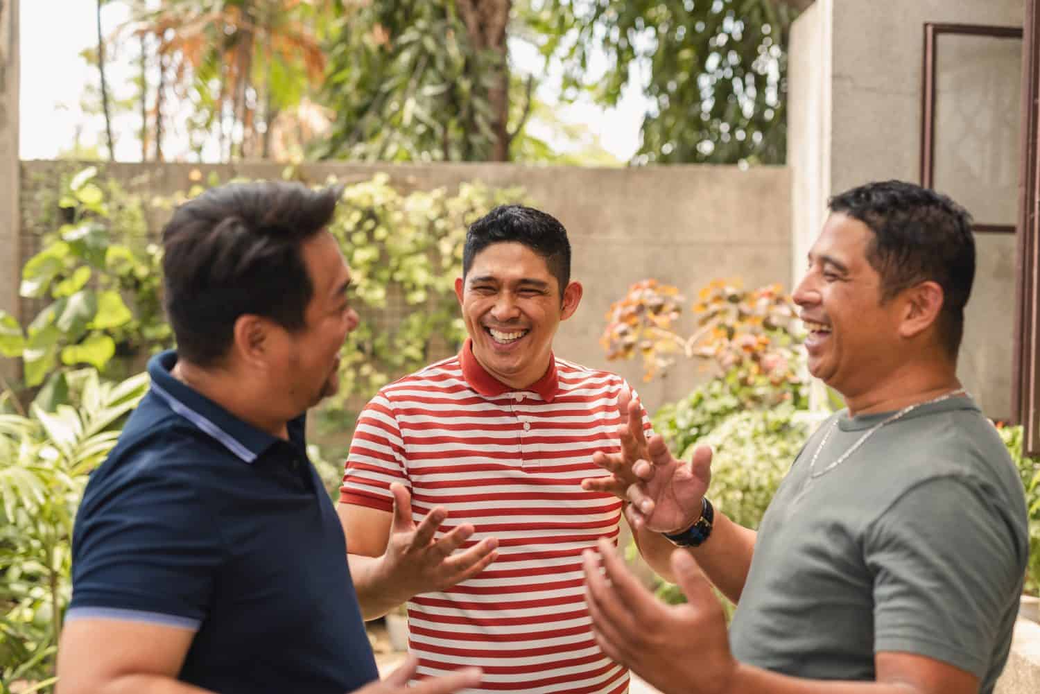 Asian men in forties sharing laughs and talks by the house, friendship and leisure concept