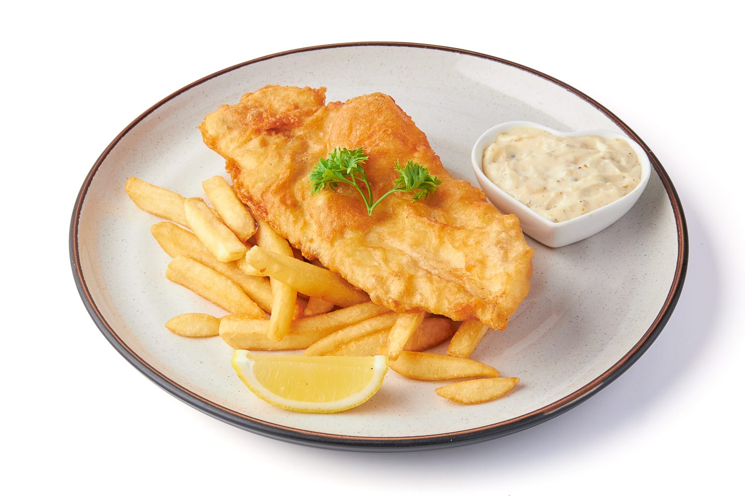 fish and chips served with french fries and tartar sauce with sliced lemon on plate isolated on white background.
