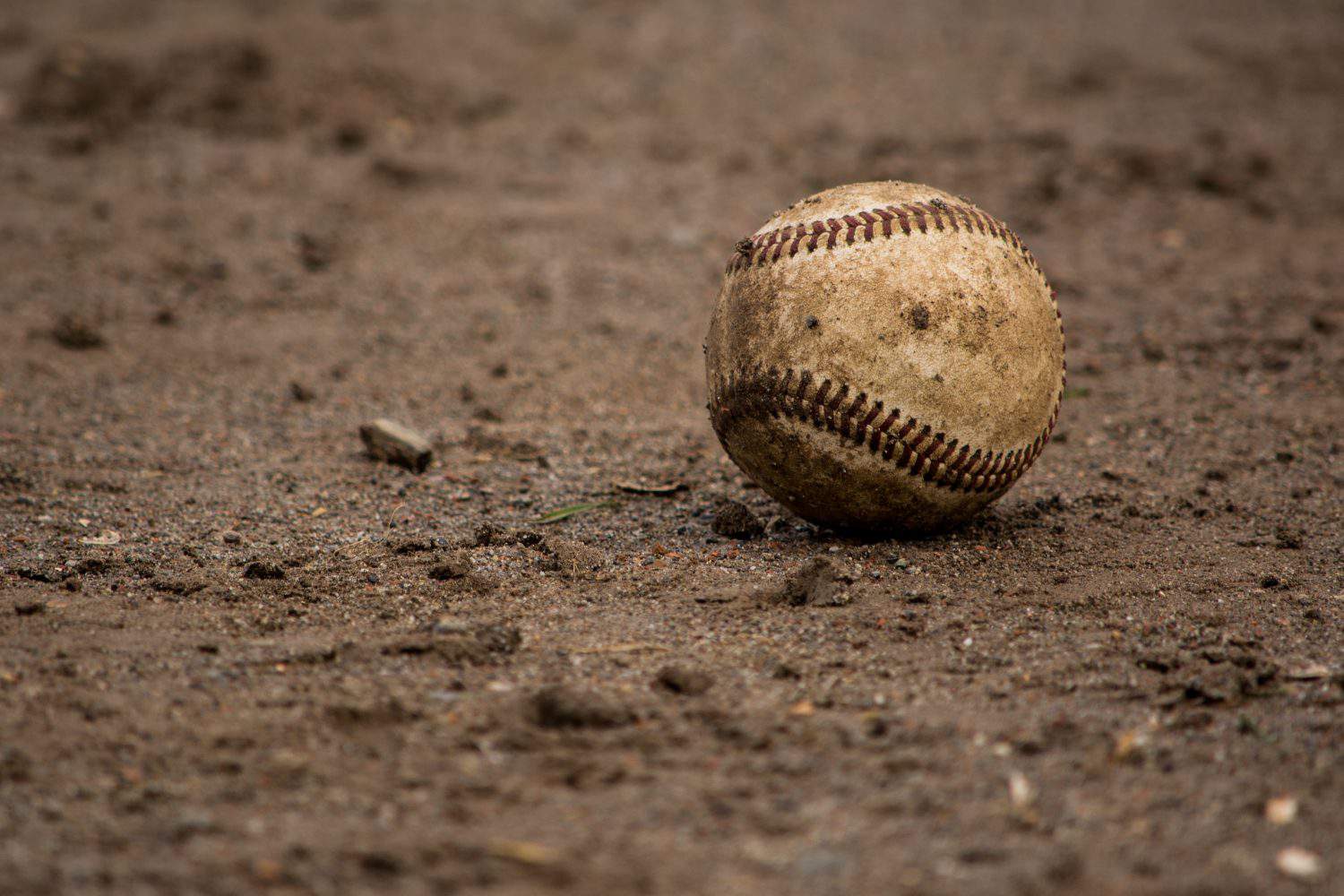 Baseball: A dirty baseball lies on the infield on game day.