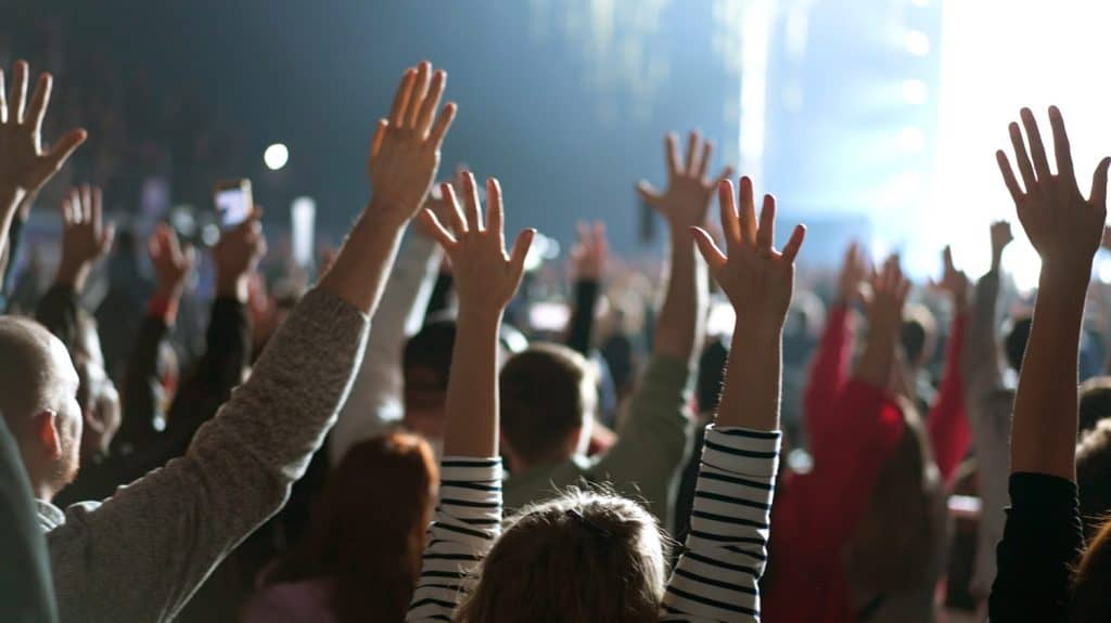 Many joy people raise hands up into sky. Fun live music concert. Sectarians crowd pray god. Lot sect fans follow faith. Holy worship concept. Epic rite open air. Big group lift arms. Huge ritual cults