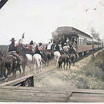 Horseback Riders Race Alongside a Train