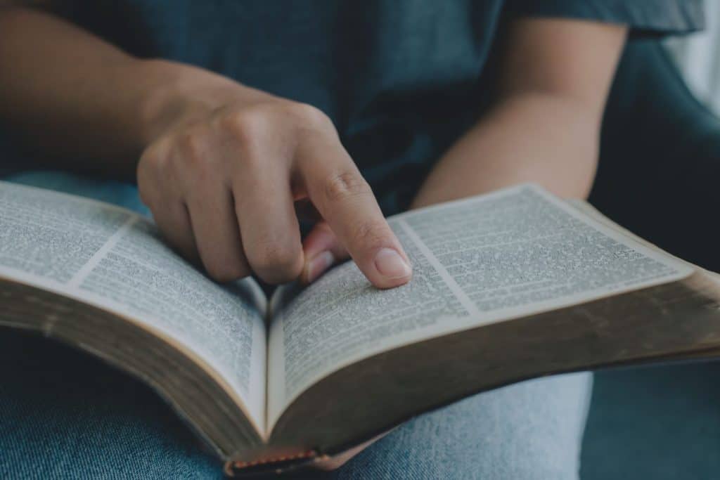 Close-up of woman hands reading the Bible. Christian background. freedom. Concept for faith, spirituality and religion