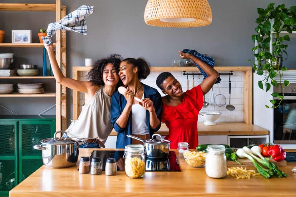 Happy beautiful hispanic south american and black women meeting indoors and having fun - Black adult females best friends spending time together, concepts about domestic life, leisure, friendship