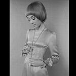 A model previews a satin dress for 1970