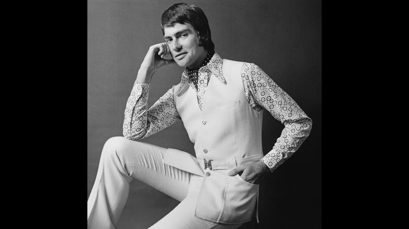 An English model in a sleeveless jerkin and patterned shirt