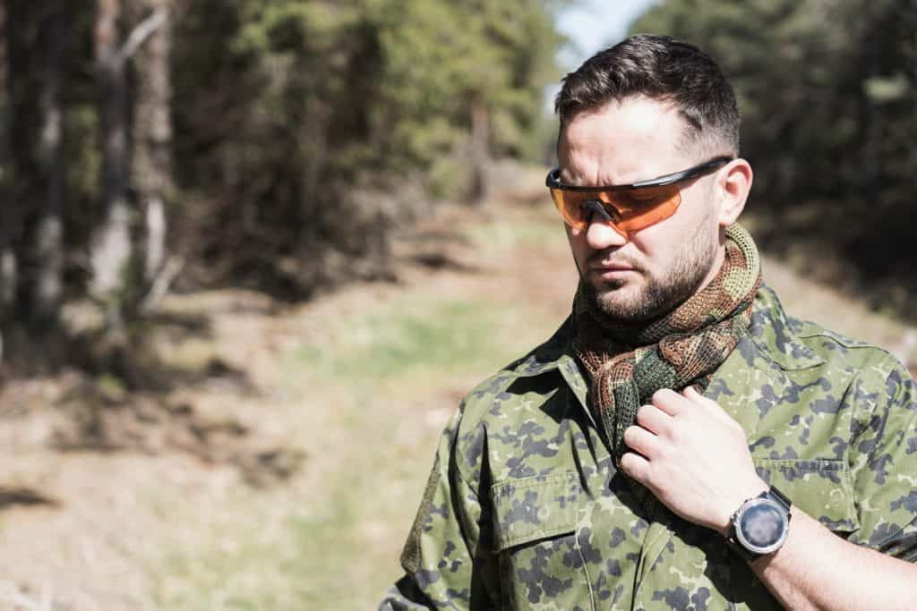 A military man of European appearance in the forest, close-up photo.