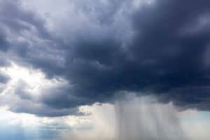 Dark clouds with torrential rain . Heavy rain stream from black clouds