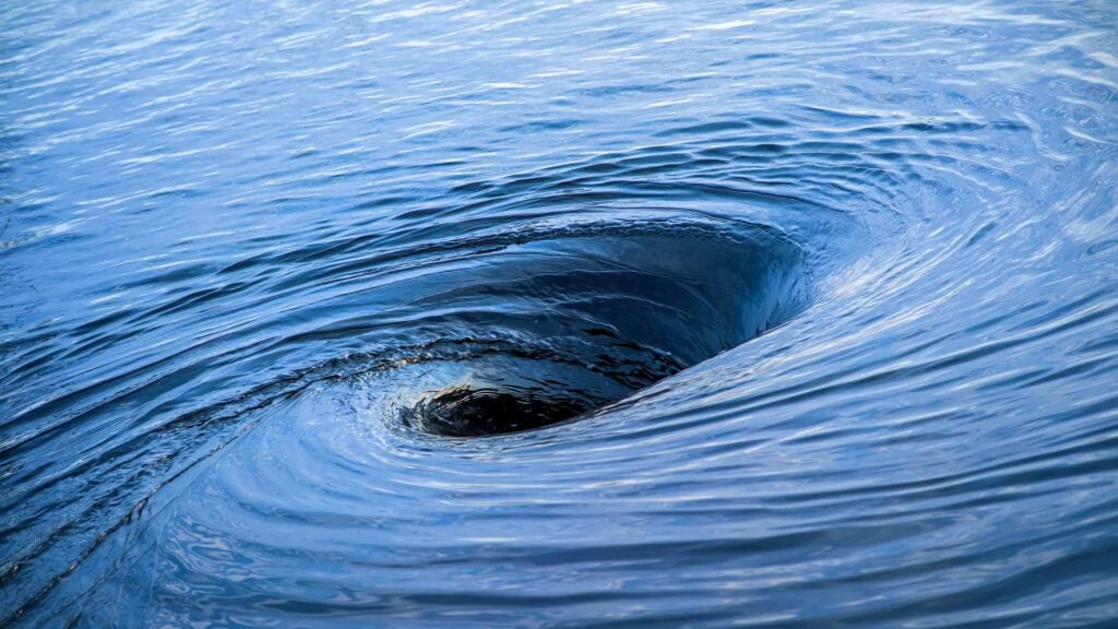 The raging whirlpool. Huge whirlpool on a water surface