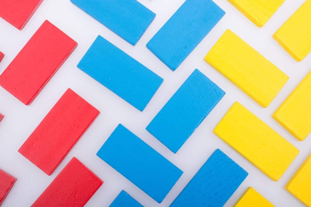 Colorful Domino Blocks in a line on a white background