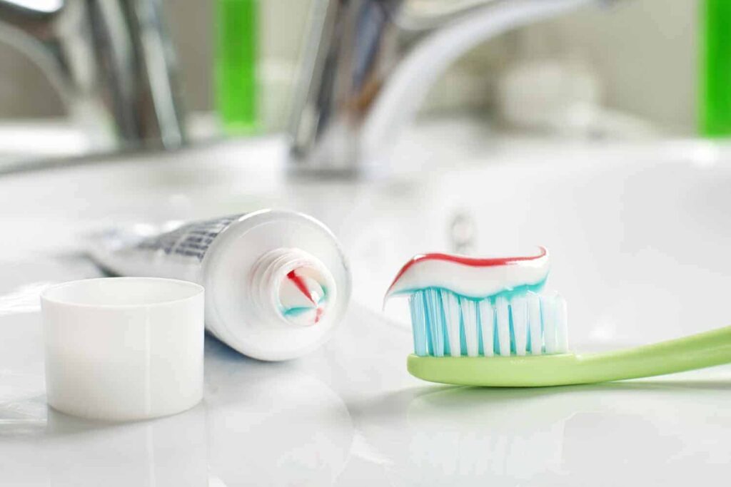 Toothbrushe and toothpaste in the bathroom close up.