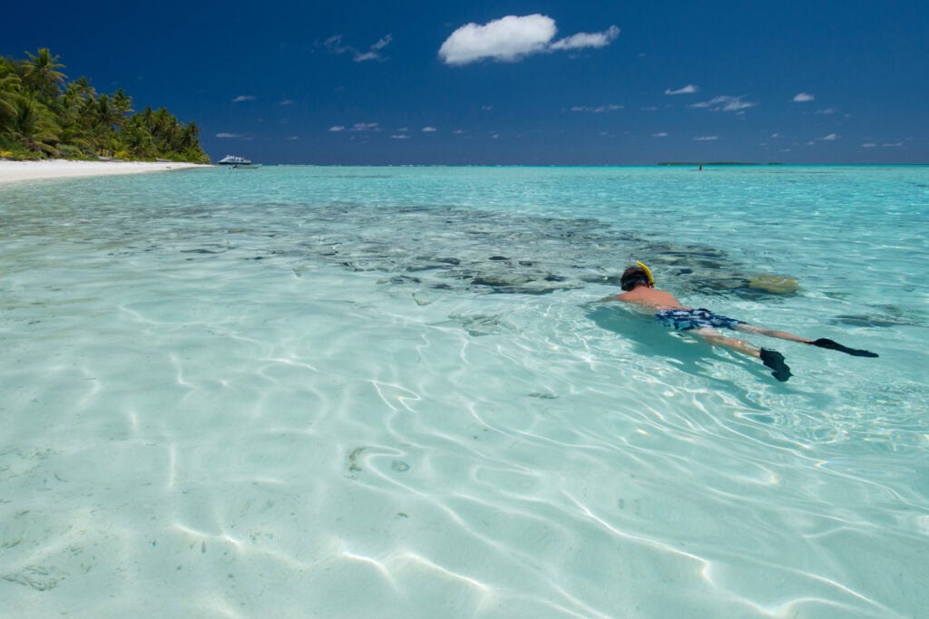 Cook Islands. Palmerston Island, a classic atoll, discovered by Captain Cook in 1774. Current population of 62 people, are all descendants of William Marsters. Snorkeling in calm lagoon with coral.