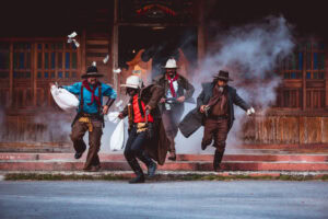 Cowboys group showing action success bank rob with fighting gun and a lot of money from rob the bank with white smoke vintage style background