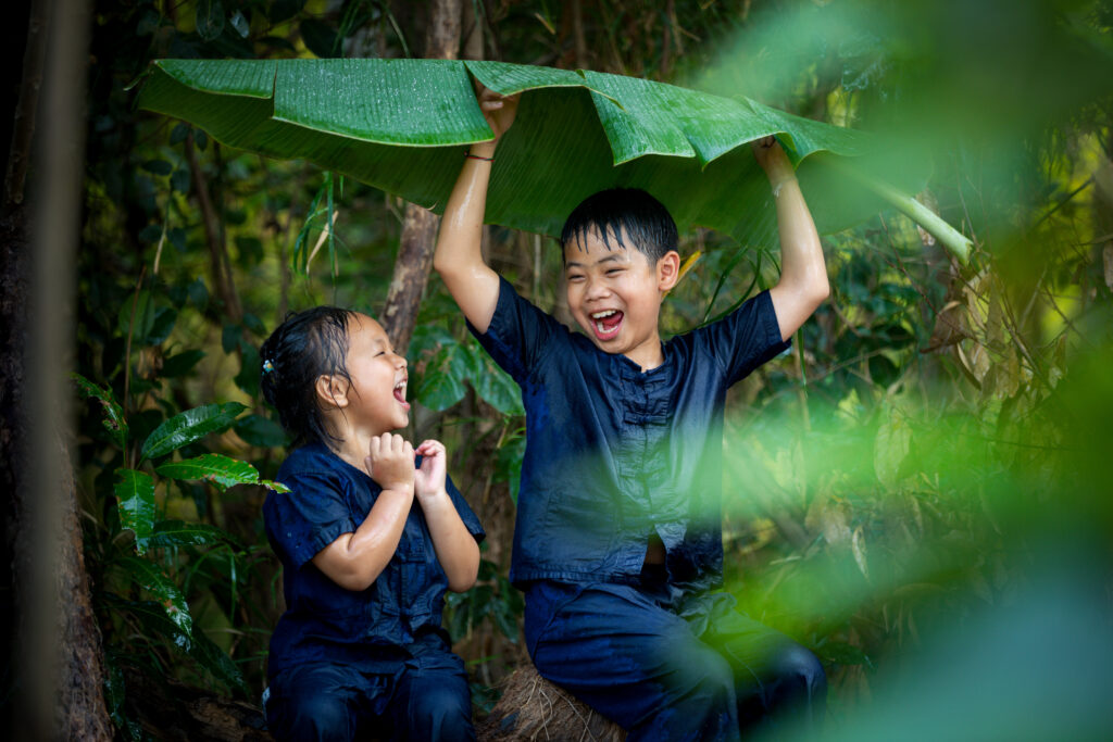 two children found a good umbrella among the raindrops.