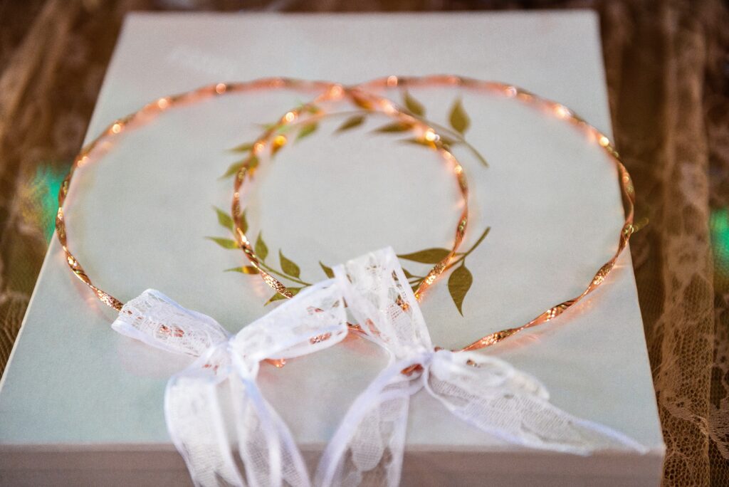 Close-up view of two golden Stefana wedding crowns, symbolizing unity and eternal love. Greek traditions. Selectiove focus.