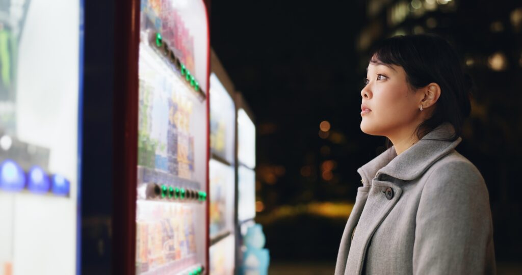 Vending machine, woman and phone payment at night, automatic digital purchase or choice of food in city outdoor. Smartphone, shopping and Japanese business person on mobile technology in urban town