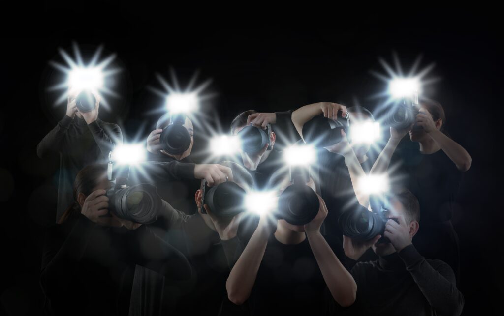 Group of photographers with cameras on black background. Paparazzi